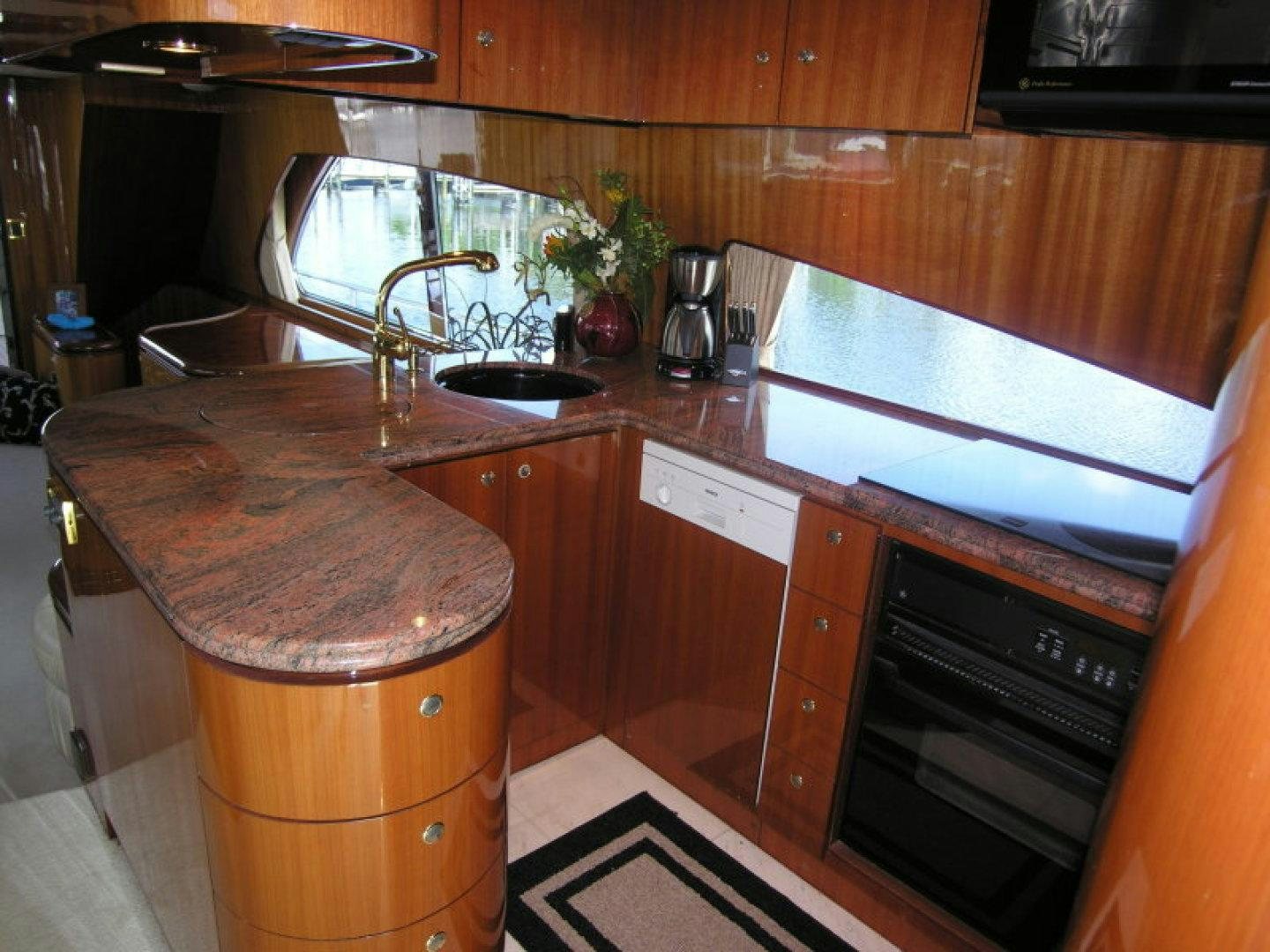 a kitchen with wooden cabinets aboard BALOZI Yacht for Sale