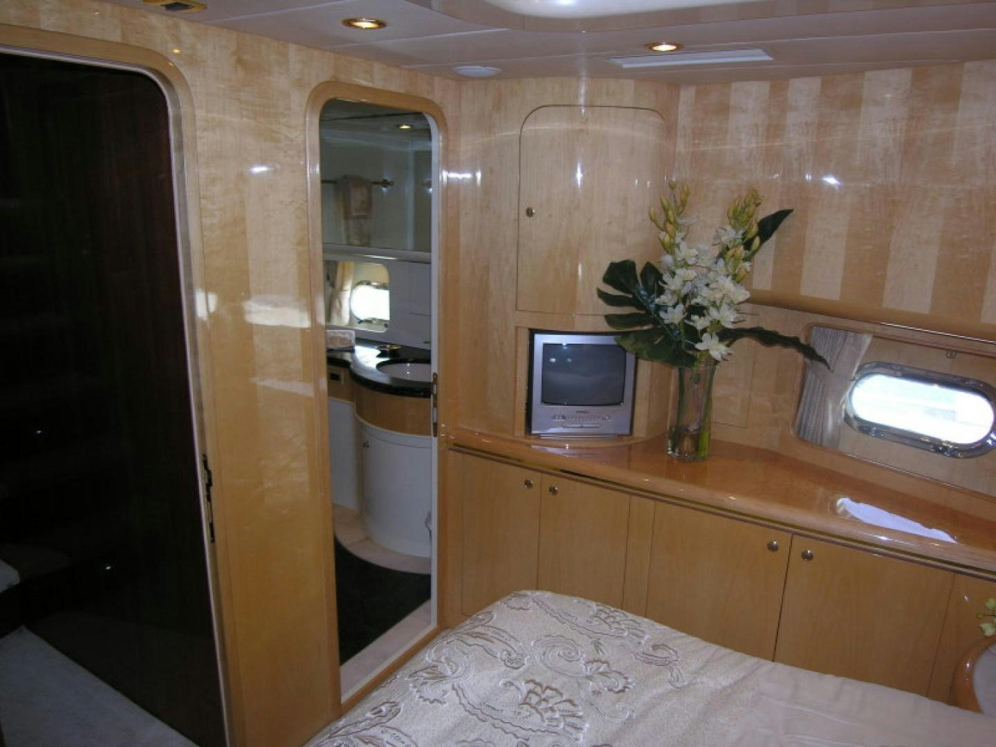 a room with a tv and a bed aboard BALOZI Yacht for Sale