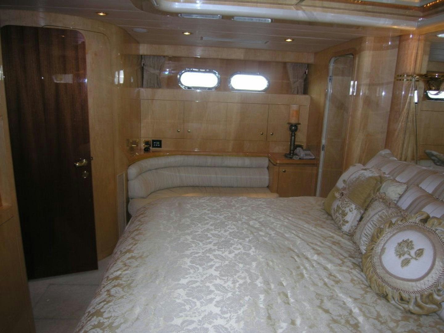 a bedroom with a bed and a door aboard BALOZI Yacht for Sale