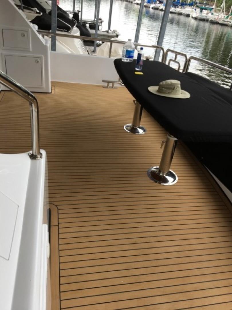 a table with a bottle of wine on it aboard BALOZI Yacht for Sale