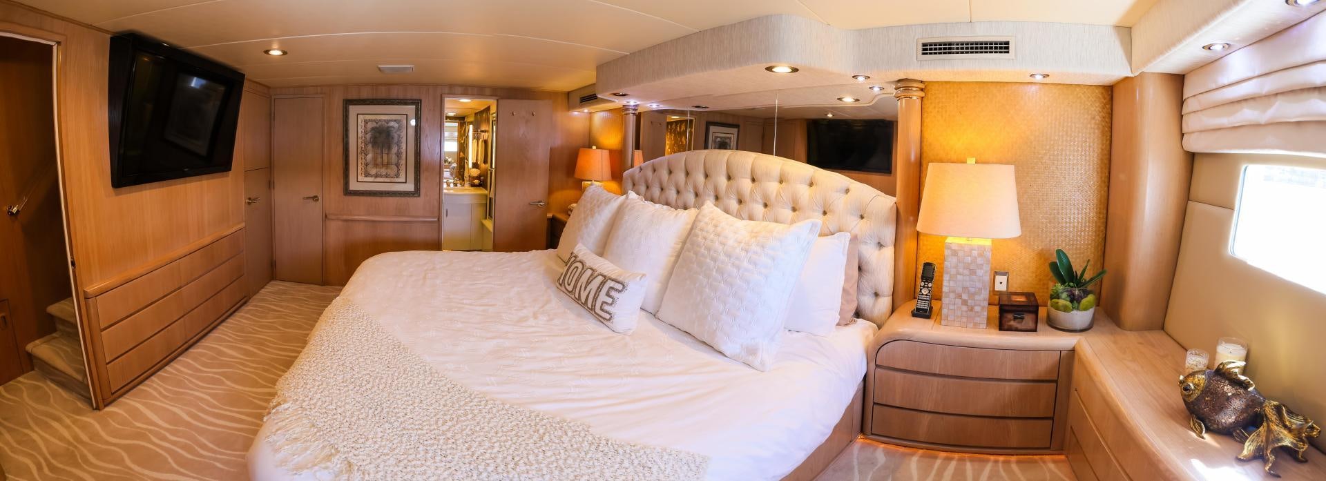 a bed with white sheets and pillows aboard FELINA Yacht for Sale