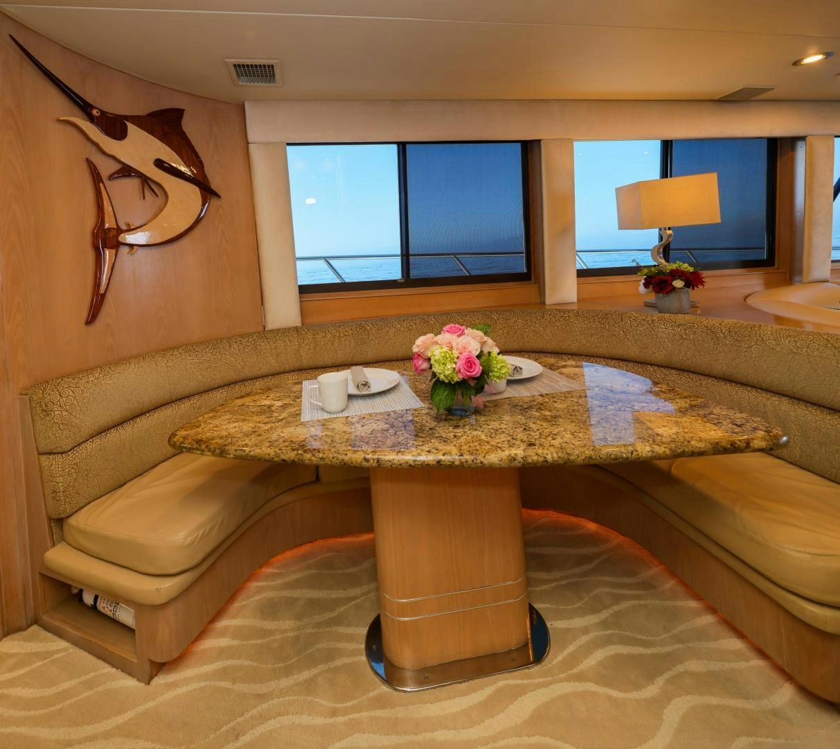 a couch with a table and chairs aboard FELINA Yacht for Sale