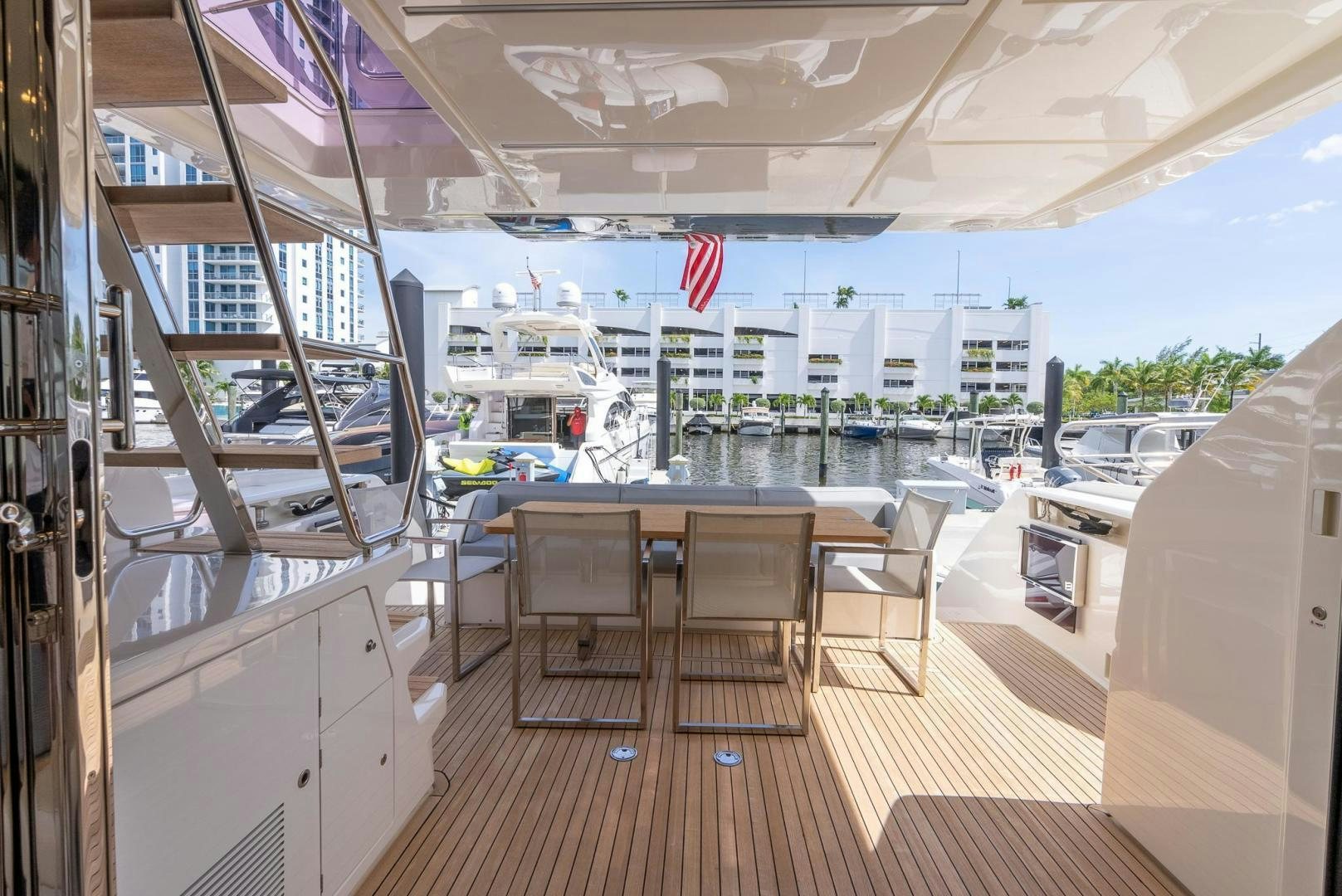 a room with a table chairs and a large window with a view of the water aboard LEGEND Yacht for Sale