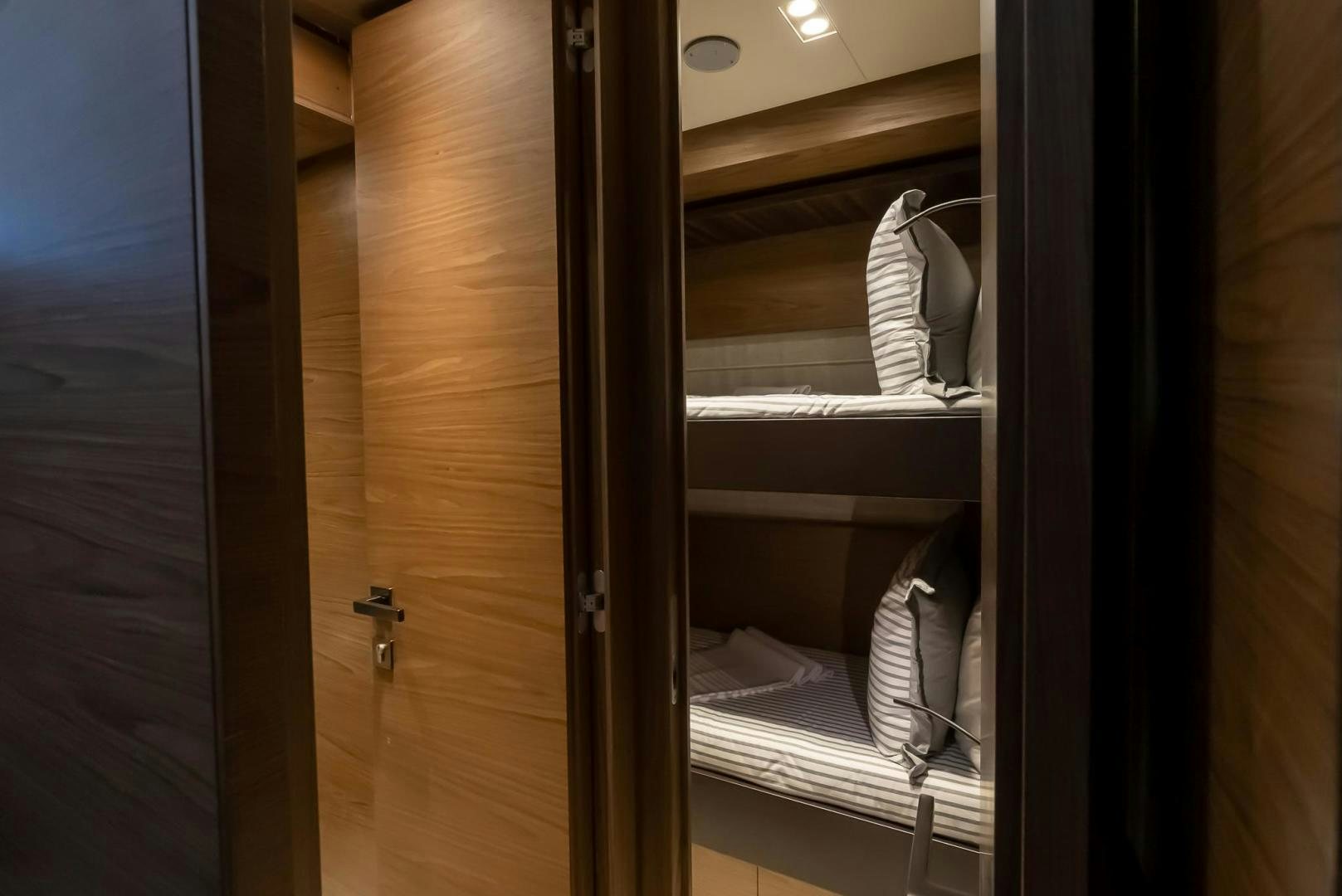a pair of white shoes on a door aboard LEGEND Yacht for Sale