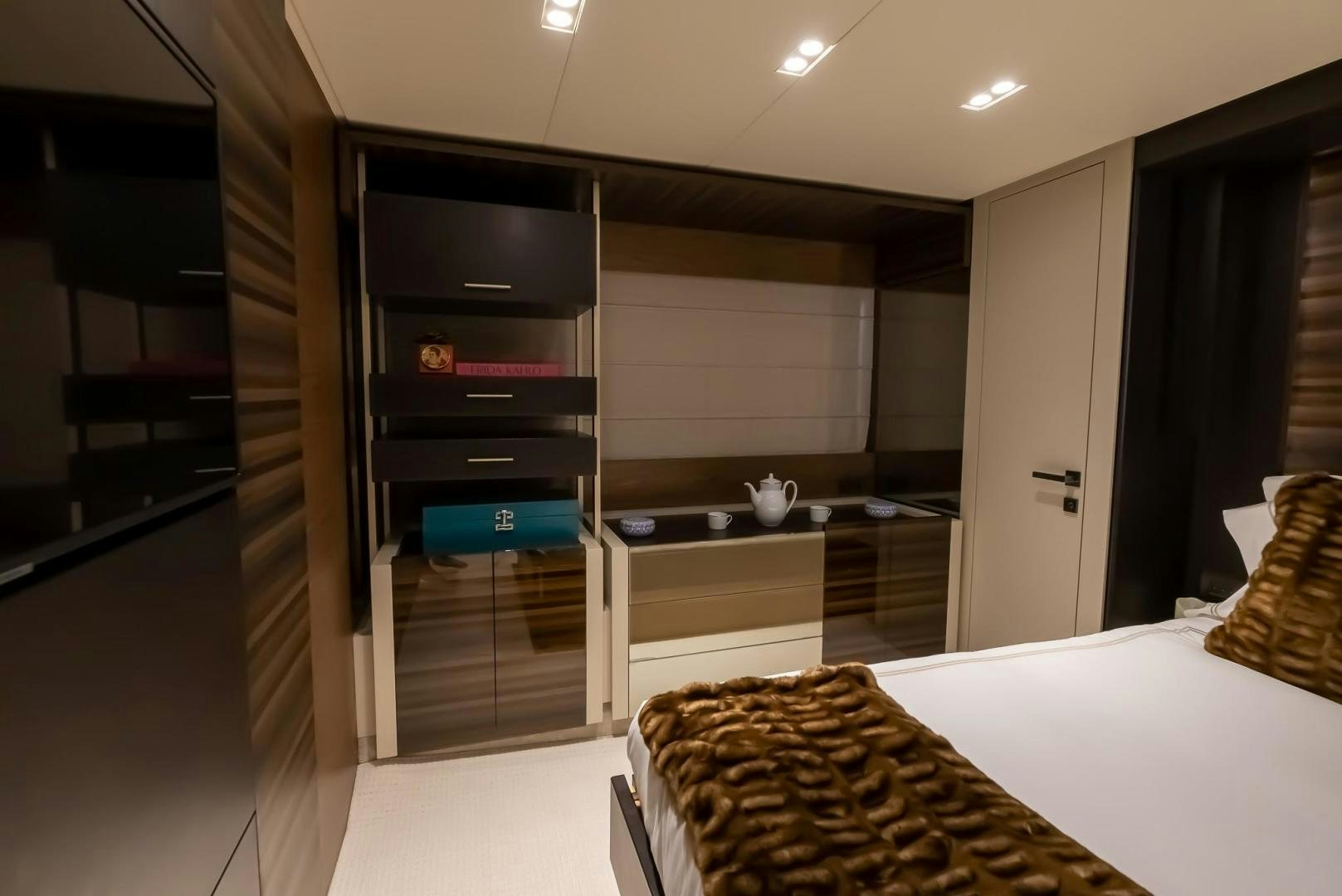 a room with a bed and a shelf with a mirror aboard LEGEND Yacht for Sale