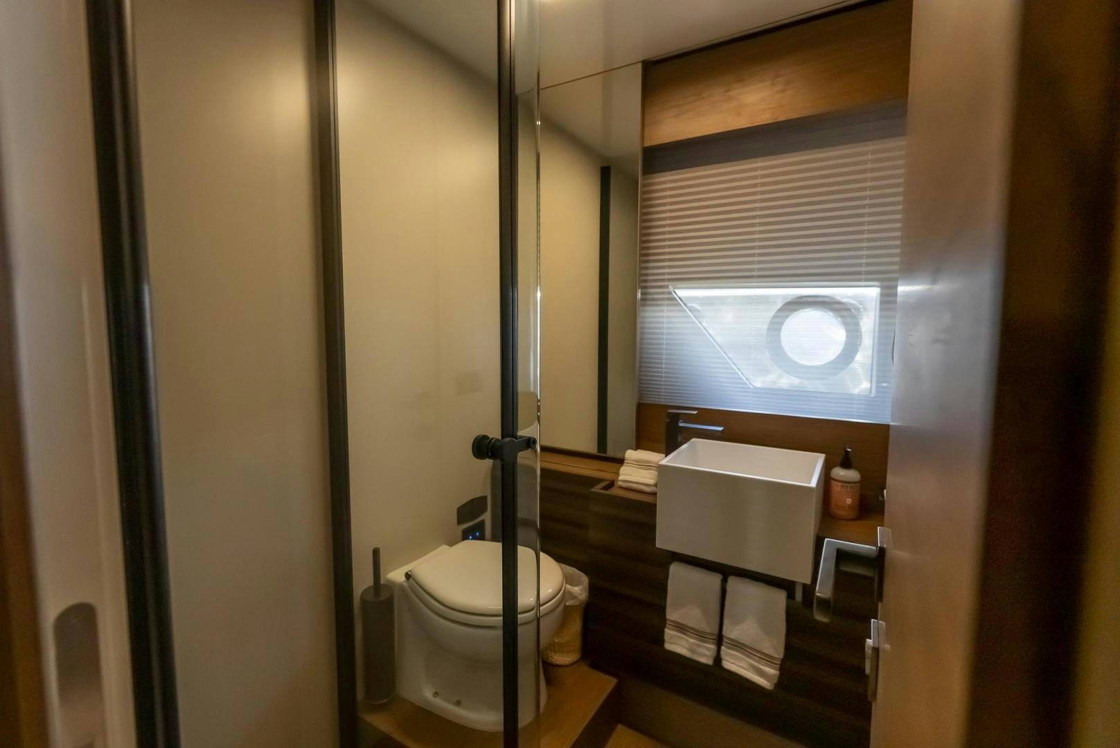 a bathroom with a toilet and a sink aboard LEGEND Yacht for Sale