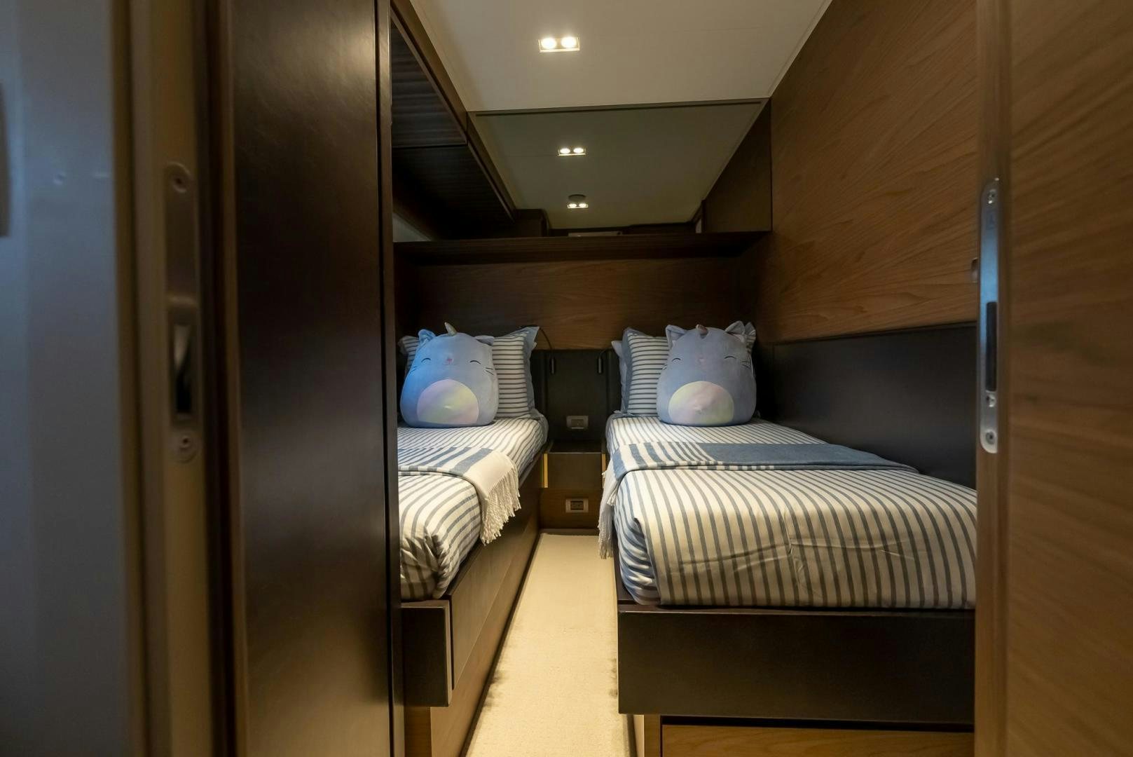 a room with beds and a mirror aboard LEGEND Yacht for Sale