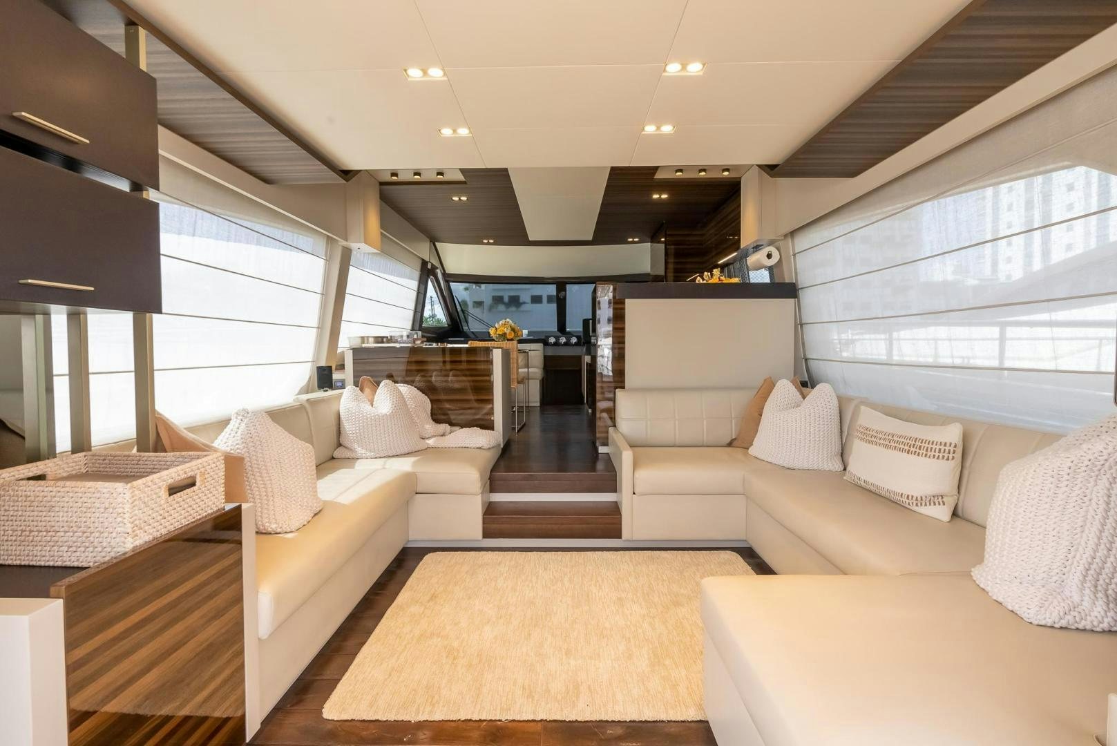 a living room with white couches aboard LEGEND Yacht for Sale
