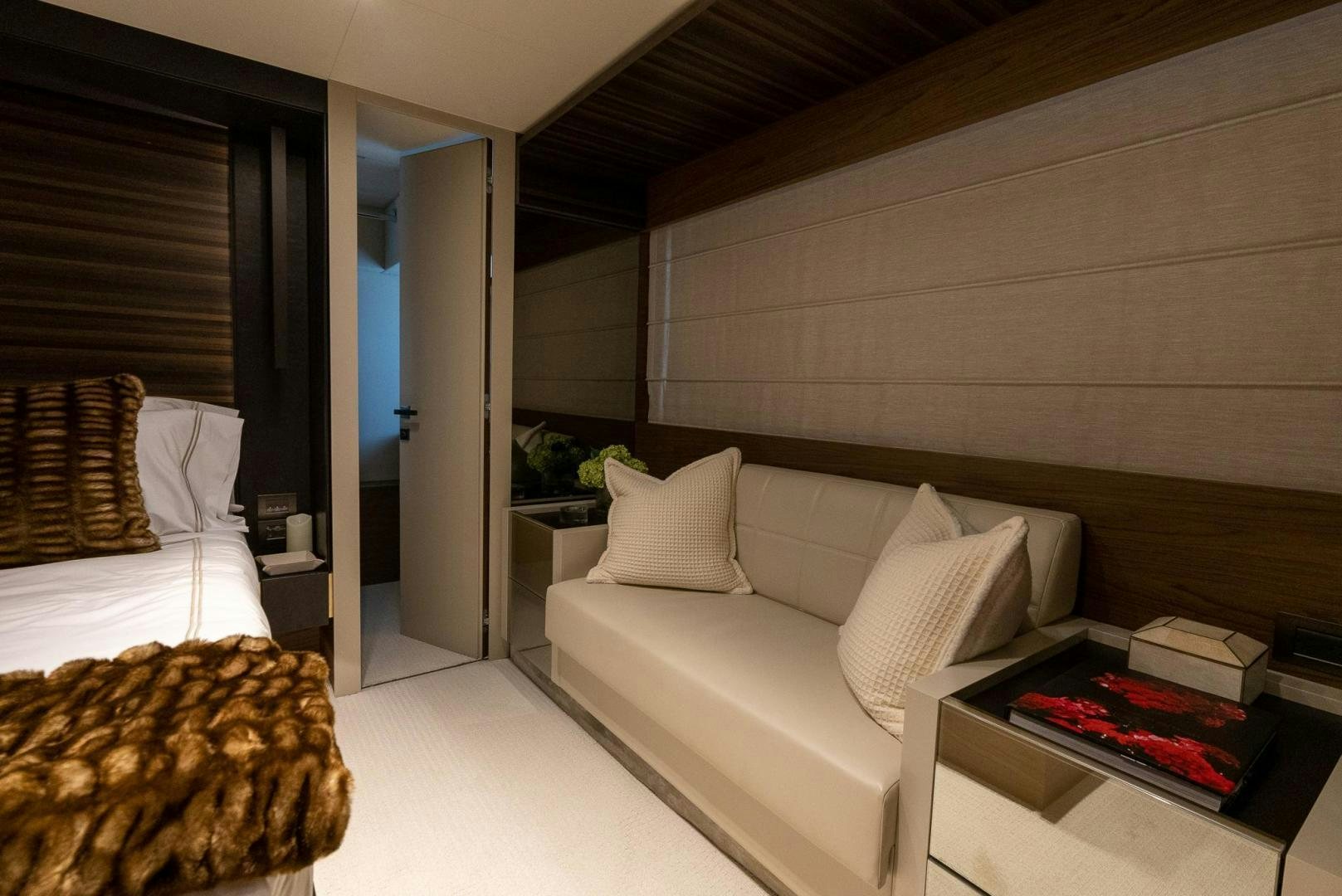 a modern bedroom with a large bed aboard LEGEND Yacht for Sale