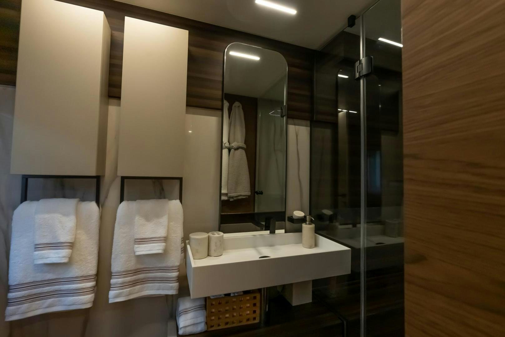 a bathroom with a large mirror aboard LEGEND Yacht for Sale