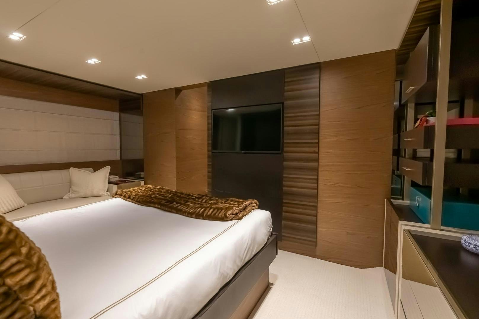 a room with a bed and a television aboard LEGEND Yacht for Sale