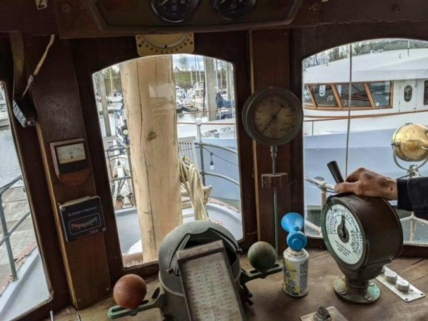 a room with a clock and a chair aboard EL PRIMERO Yacht for Sale