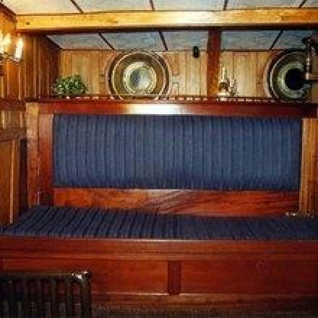 a wooden bar with a round metal bar aboard EL PRIMERO Yacht for Sale