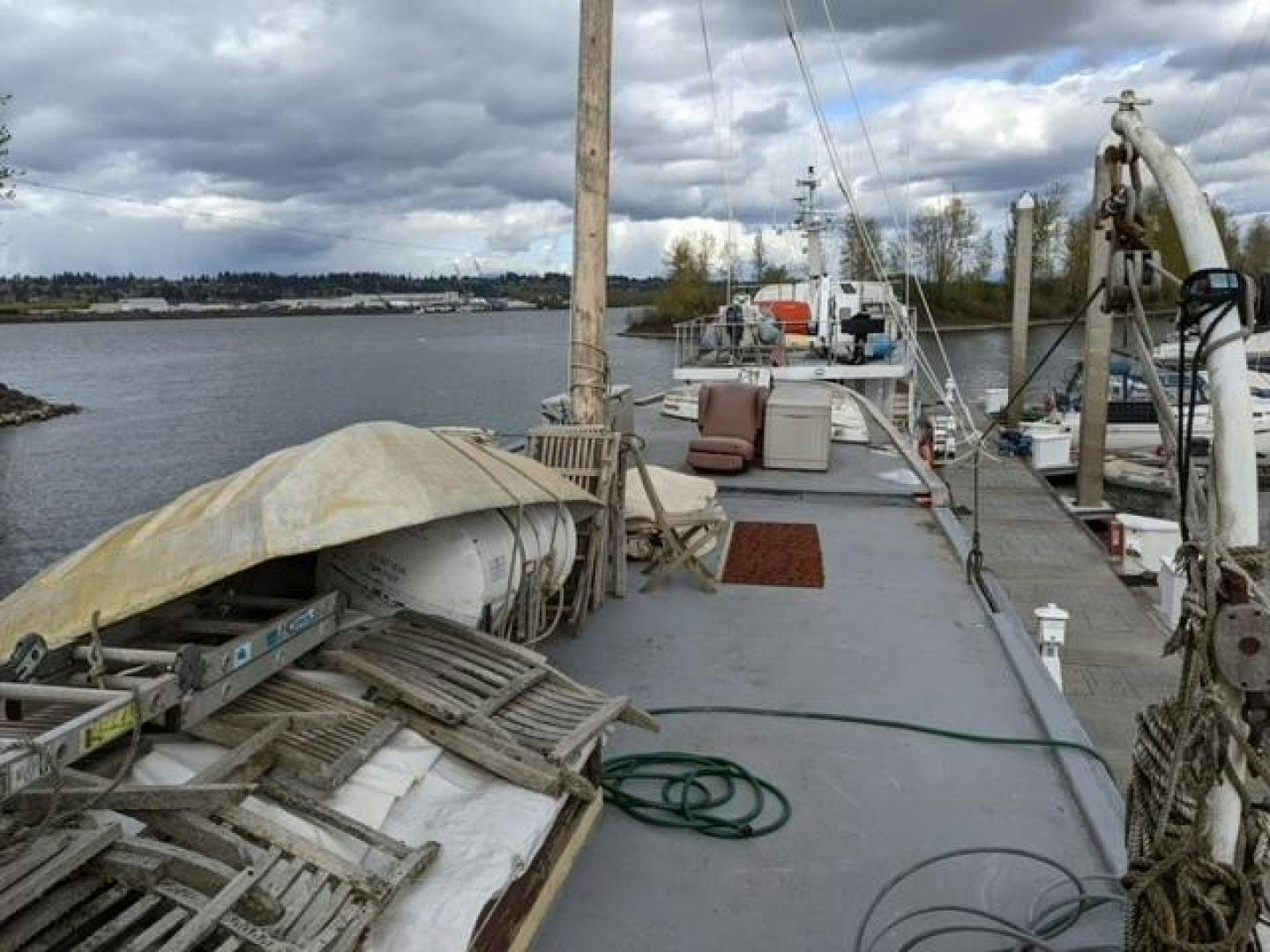 a dock with a boat and a crane aboard EL PRIMERO Yacht for Sale