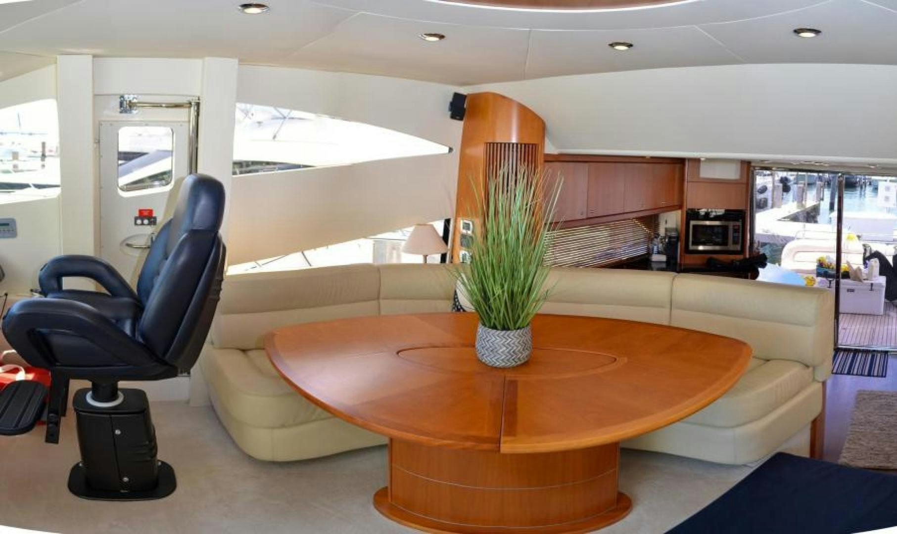 a table with a plant in a room with chairs and a table aboard PEARL Yacht for Sale