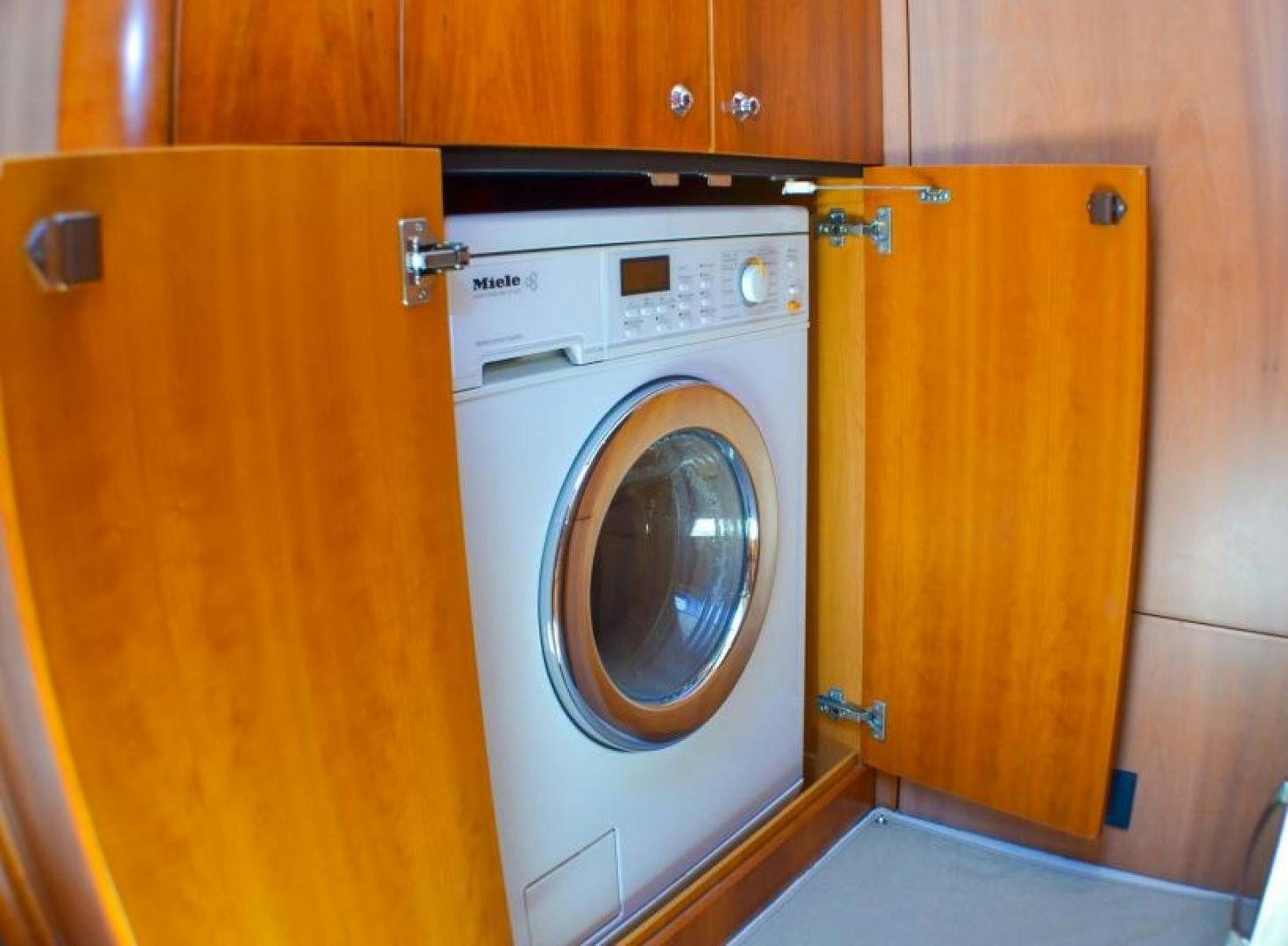 a closet with a washing machine aboard PEARL Yacht for Sale