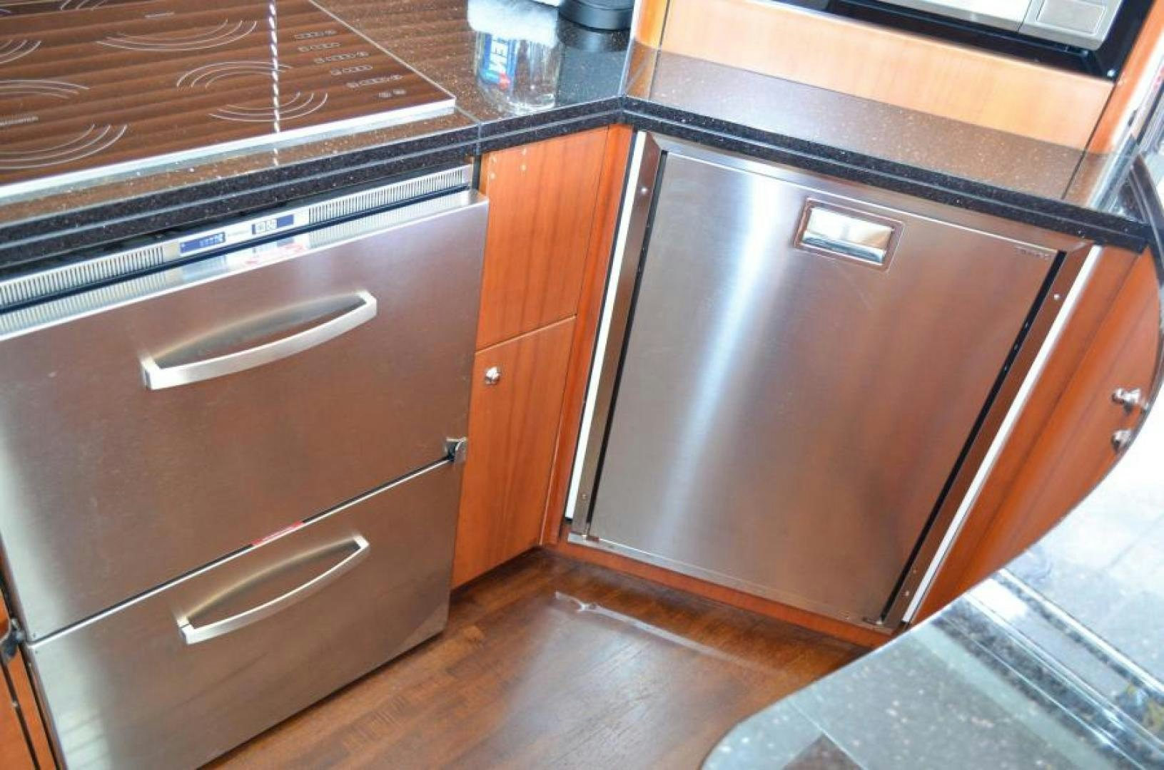 a kitchen with wooden cabinets aboard PEARL Yacht for Sale