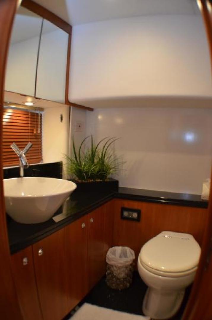 a bathroom with a toilet sink and a mirror aboard PEARL Yacht for Sale