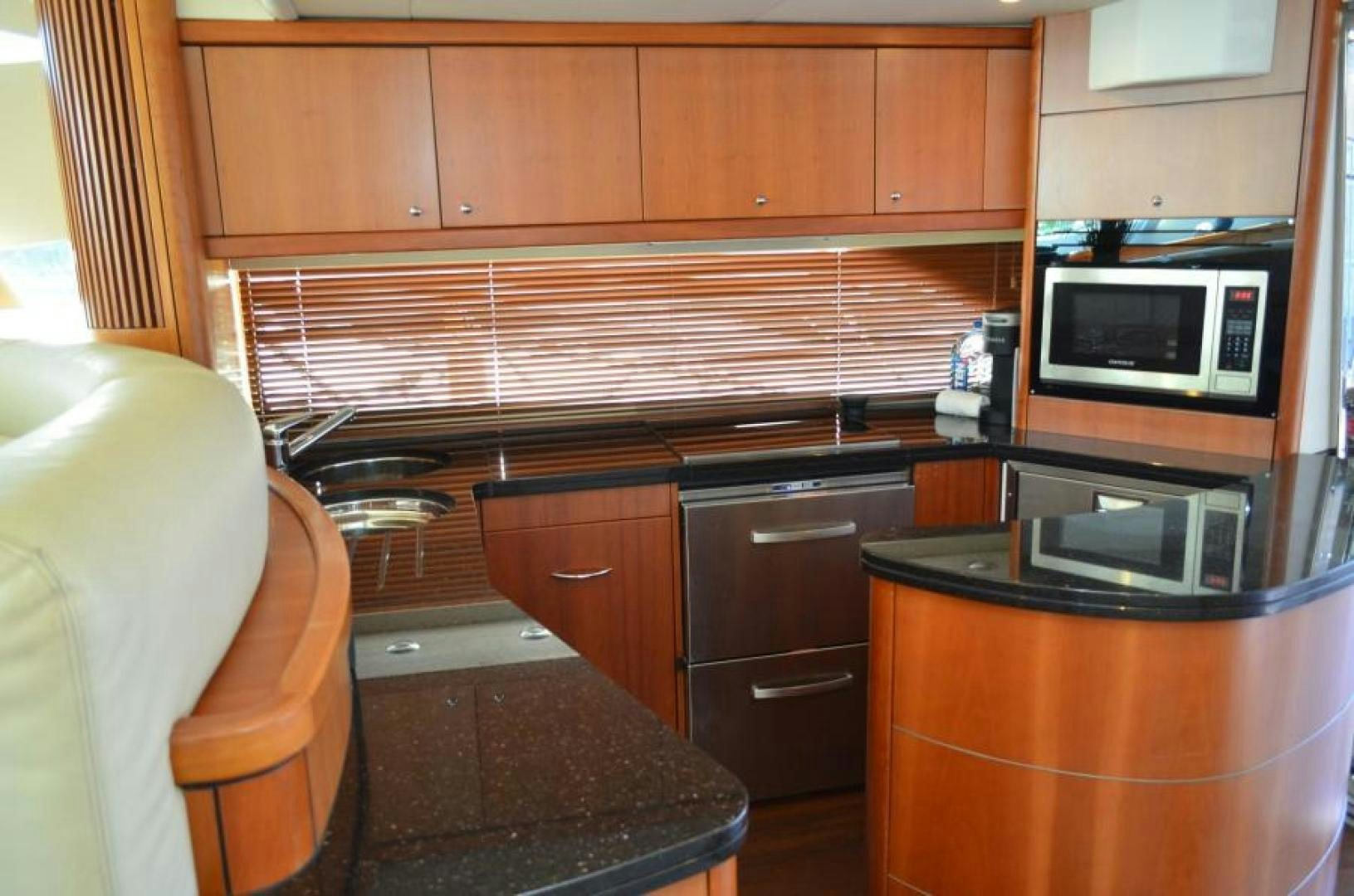 a kitchen with wooden cabinets aboard PEARL Yacht for Sale