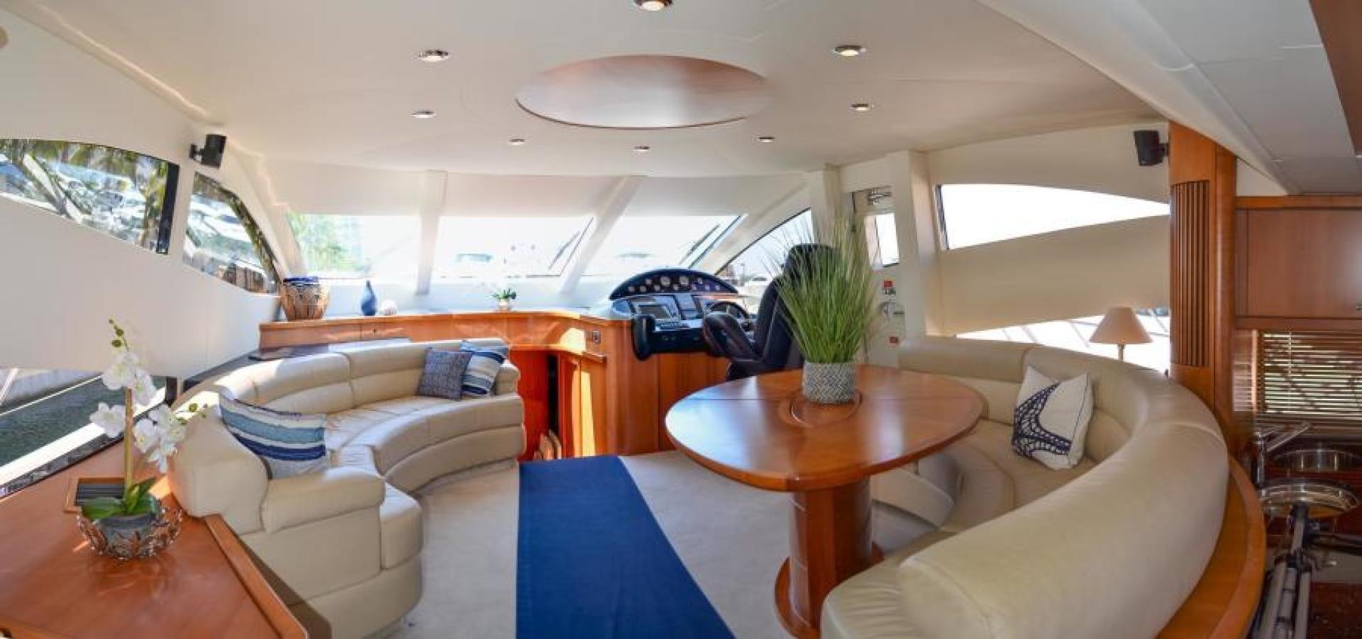 a living room with a table and couches aboard PEARL Yacht for Sale