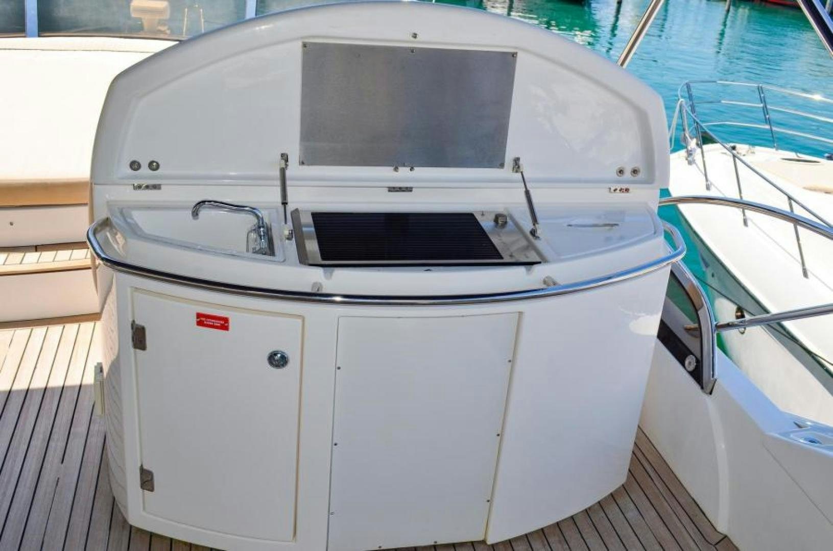 a white boat with a black and red stripe on the front aboard PEARL Yacht for Sale