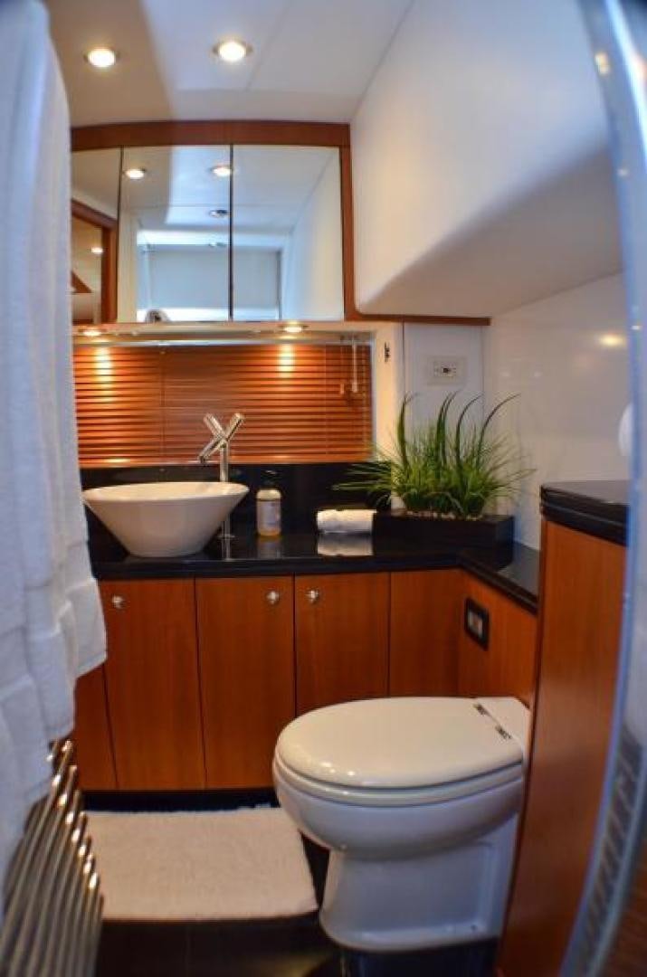 a bathroom with a sink toilet and a mirror aboard PEARL Yacht for Sale