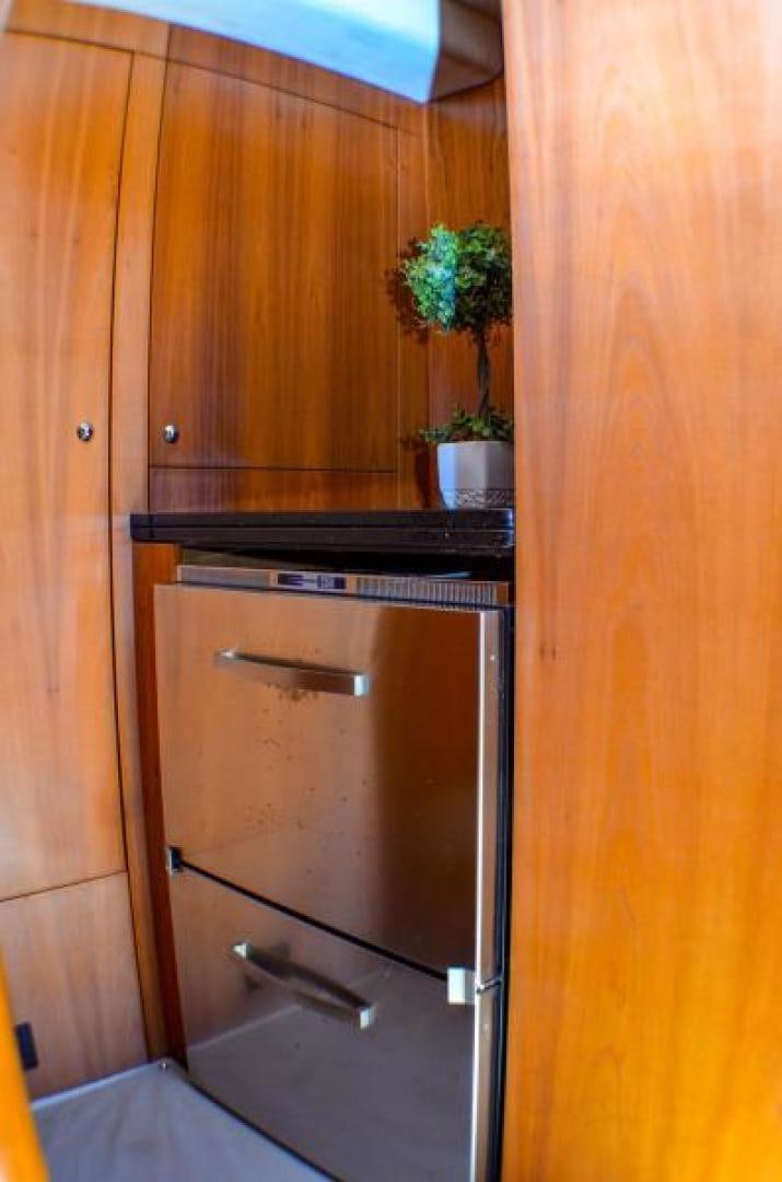 a kitchen with wooden cabinets aboard PEARL Yacht for Sale
