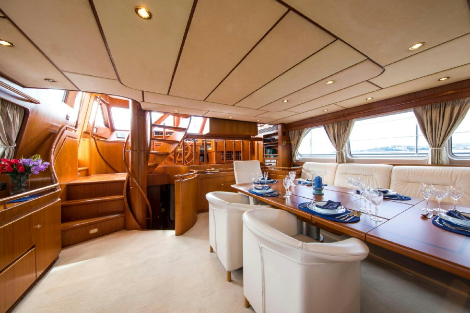 a room with a table chairs and a window aboard FIDELITAS Yacht for Sale