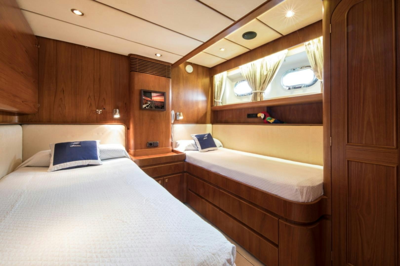 a room with a bed and a desk aboard FIDELITAS Yacht for Sale
