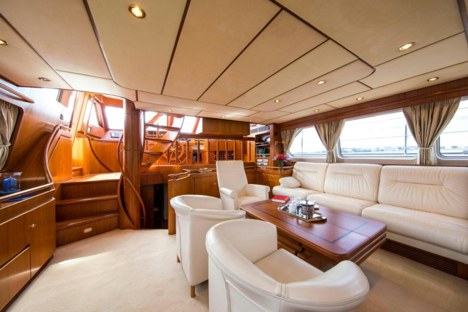 a room with a couch and a table and chairs aboard FIDELITAS Yacht for Sale