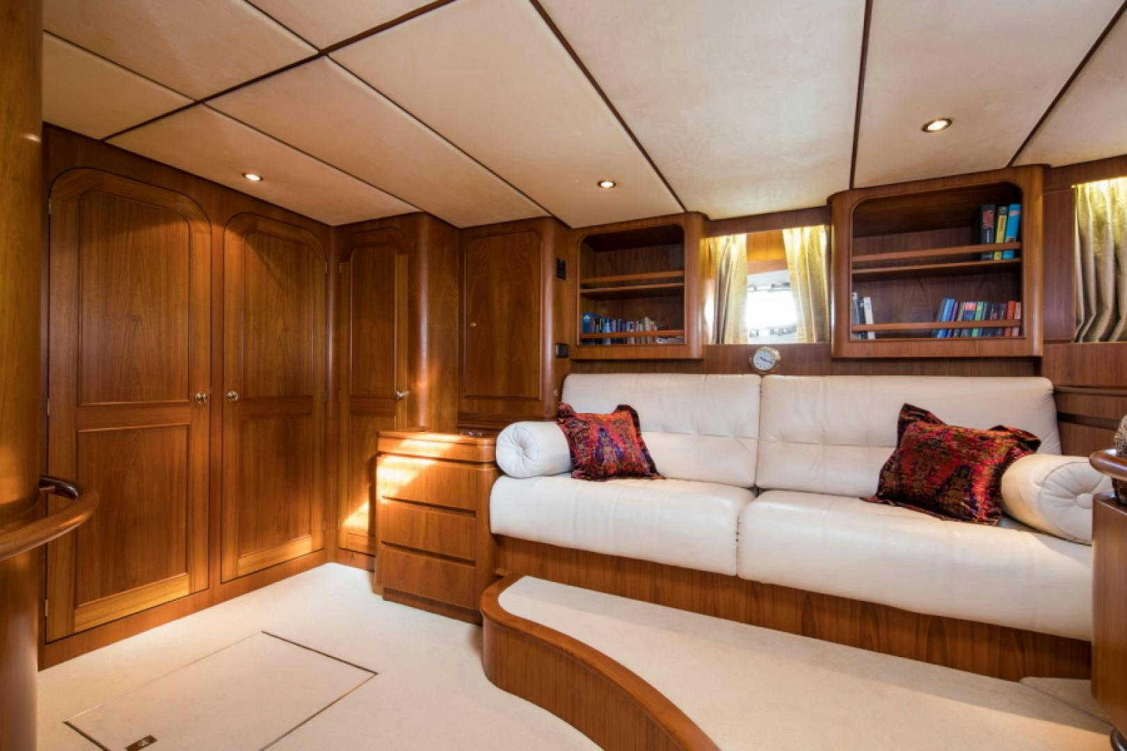 a living room with a white couch aboard FIDELITAS Yacht for Sale