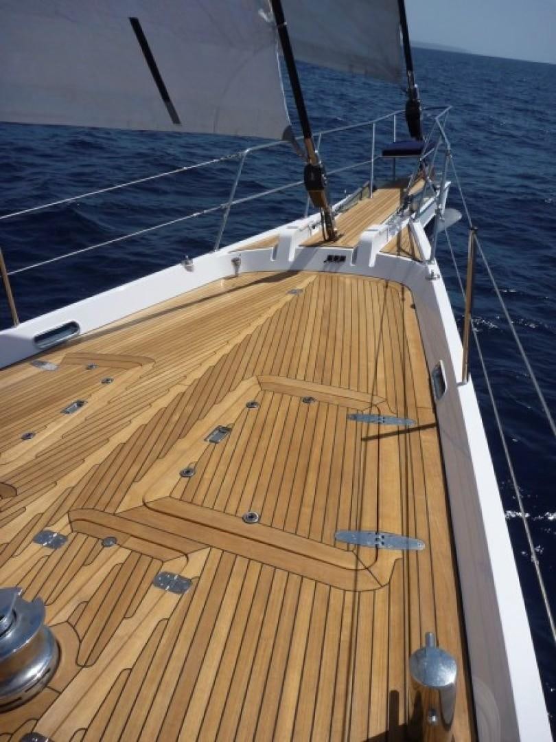 a ship deck with a deck and a deck with a deck and a large ship in the water aboard FIDELITAS Yacht for Sale