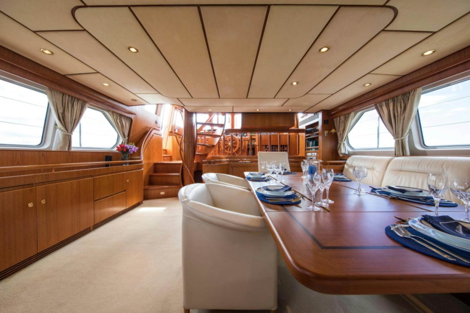 a room with a table chairs and a window aboard FIDELITAS Yacht for Sale
