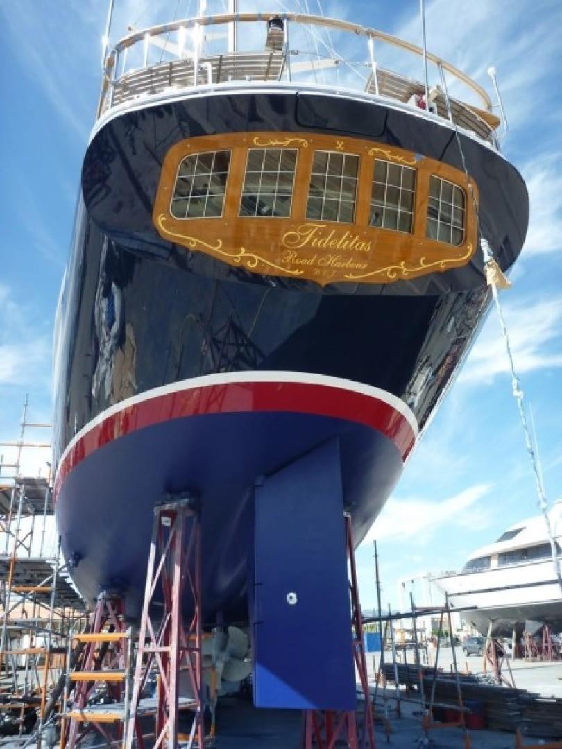 a large blue and red boat aboard FIDELITAS Yacht for Sale