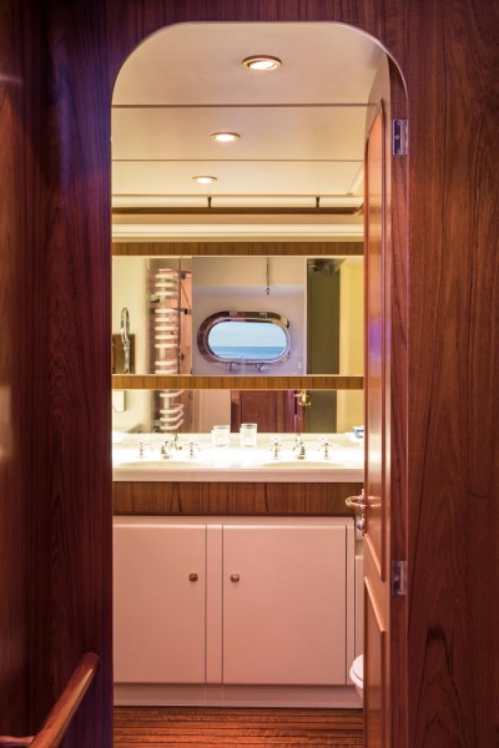 a bathroom with a large mirror aboard FIDELITAS Yacht for Sale