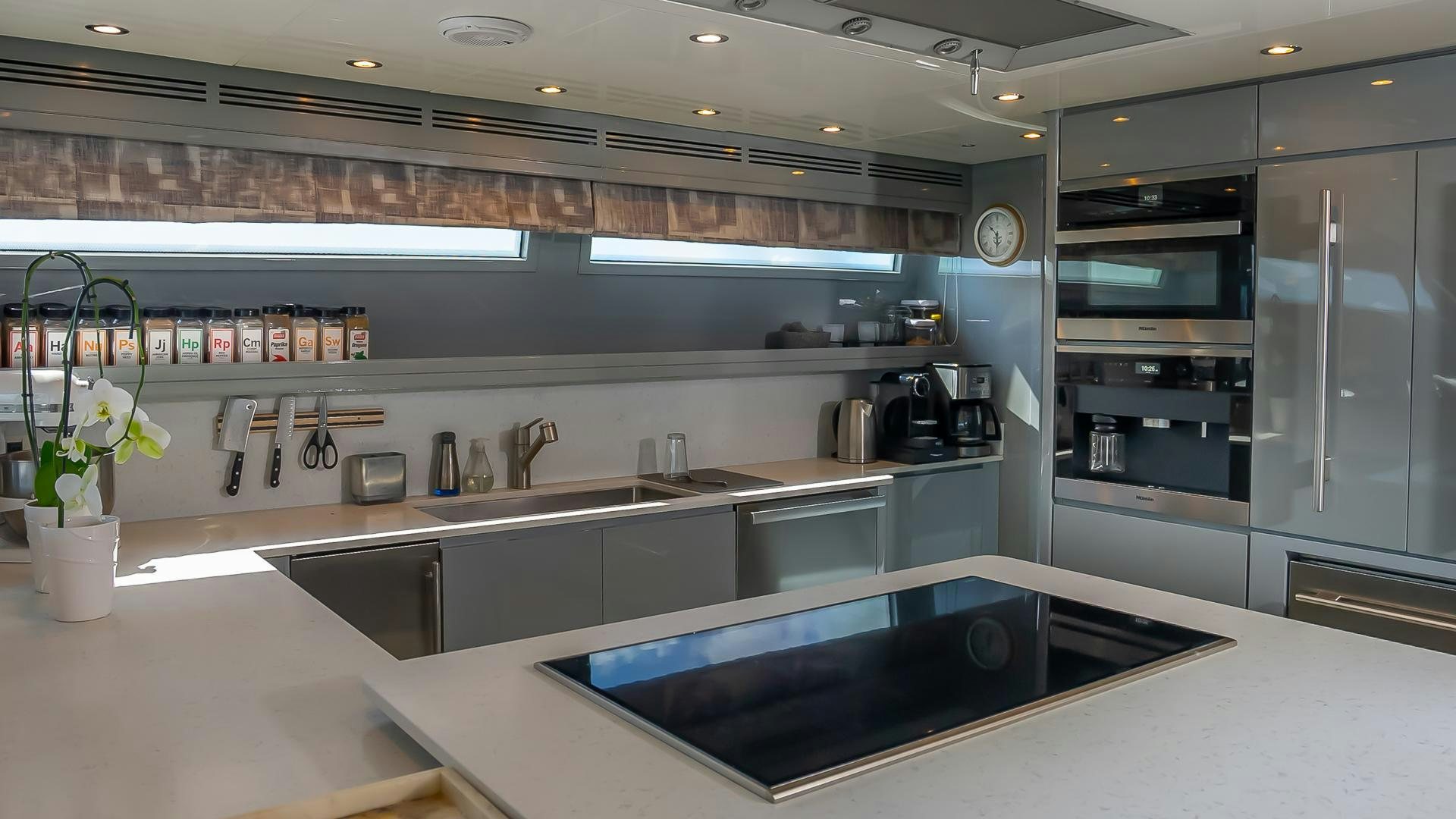 a kitchen with a large island aboard BAD ROMANCE IV Yacht for Sale