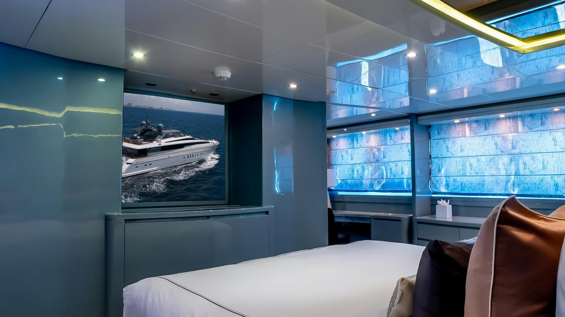 a room with a bed and a large window aboard BAD ROMANCE IV Yacht for Sale