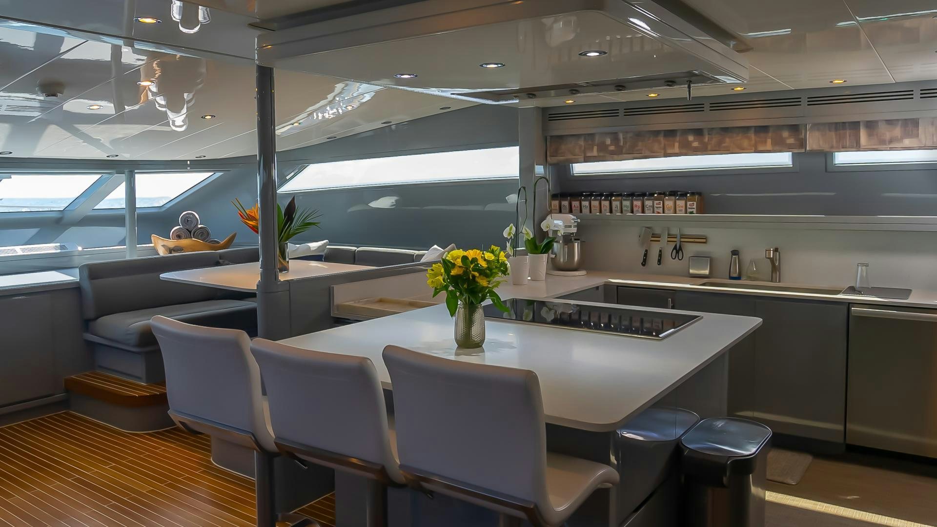 a large kitchen with a large glass wall aboard BAD ROMANCE IV Yacht for Sale