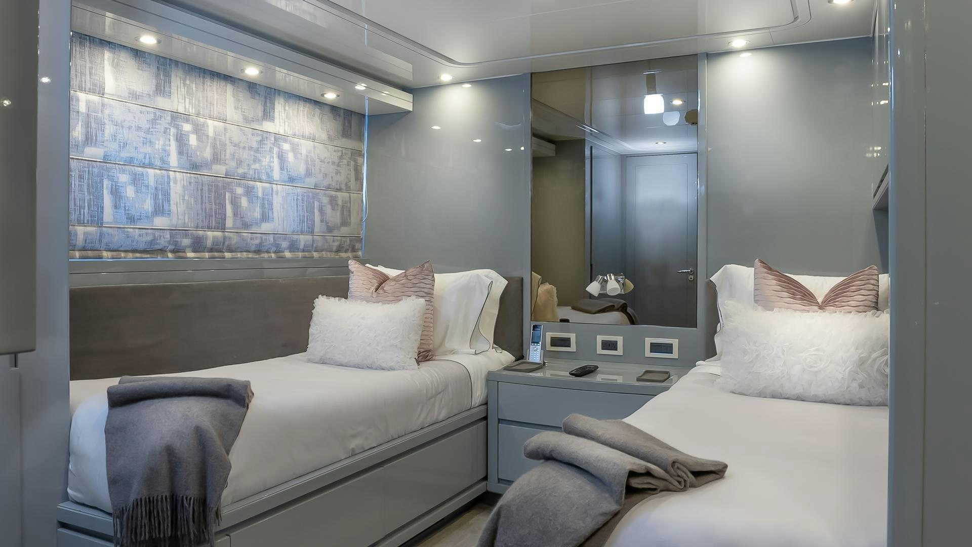 a room with two beds aboard BAD ROMANCE IV Yacht for Sale