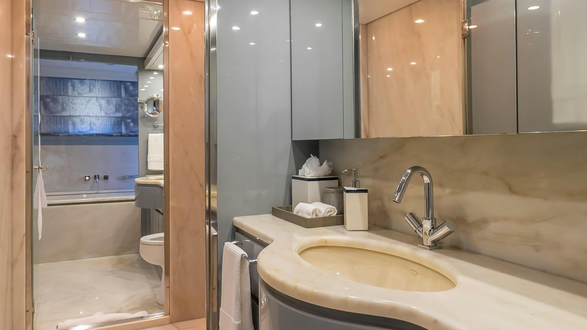 a bathroom with a sink and a mirror aboard BAD ROMANCE IV Yacht for Sale