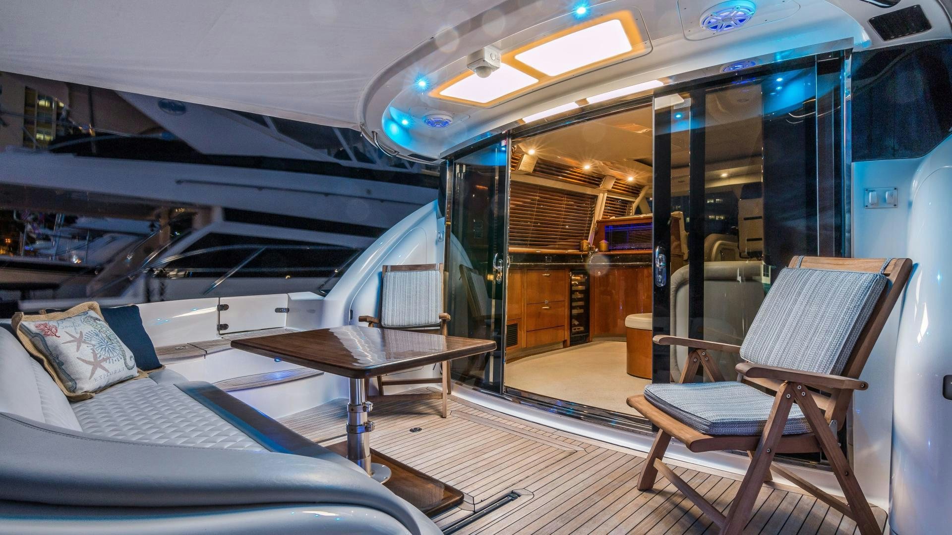 a train with a bench and a table aboard XANADU Yacht for Sale