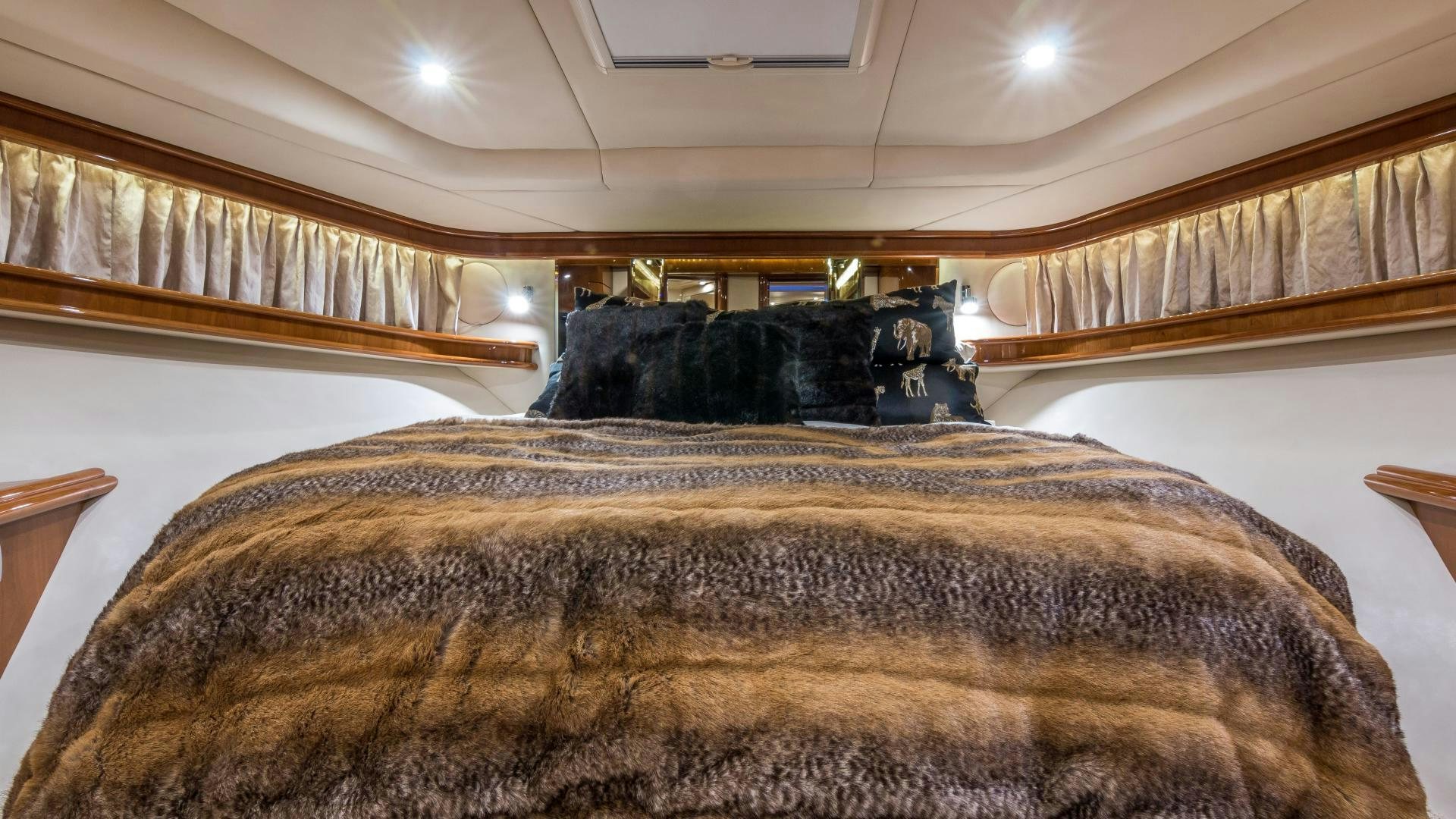 a bed with a brown comforter aboard XANADU Yacht for Sale