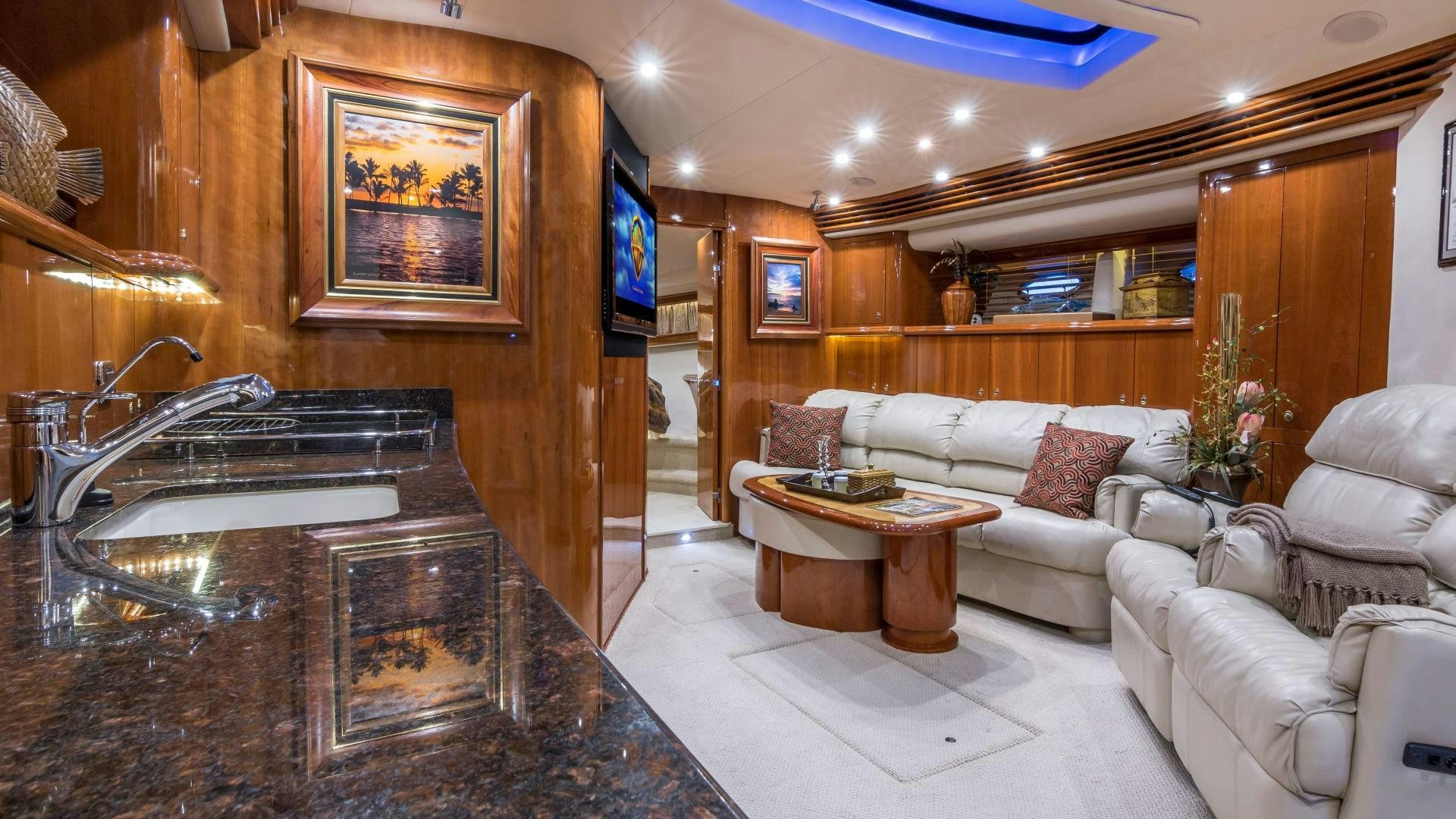 a living room with a white couch and a table aboard XANADU Yacht for Sale