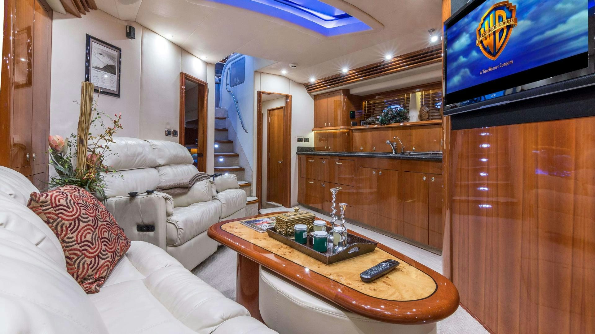 a living room with a table and couches aboard XANADU Yacht for Sale
