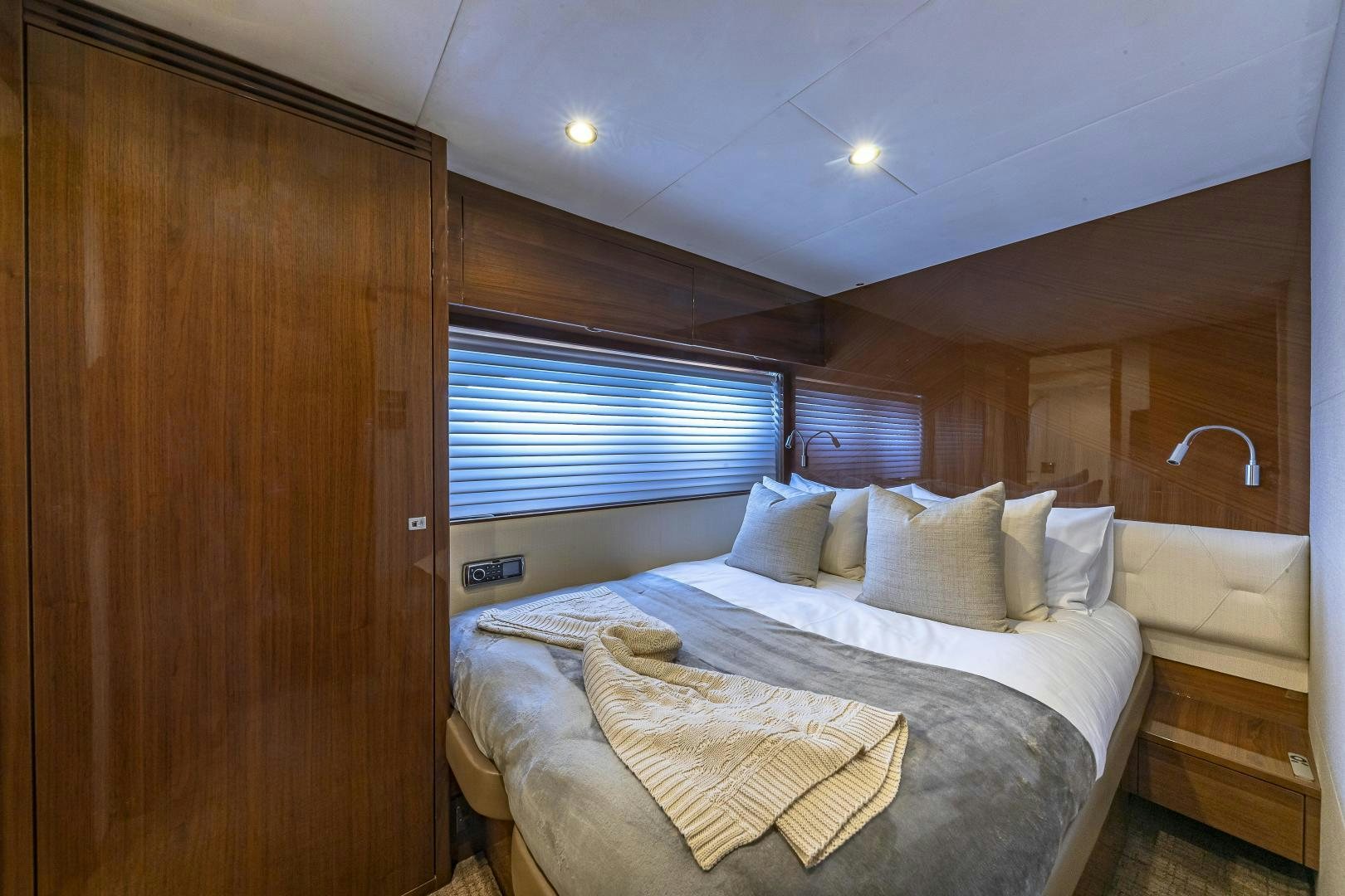 a room with a bed and a wood door aboard GOOD LIFE Yacht for Sale