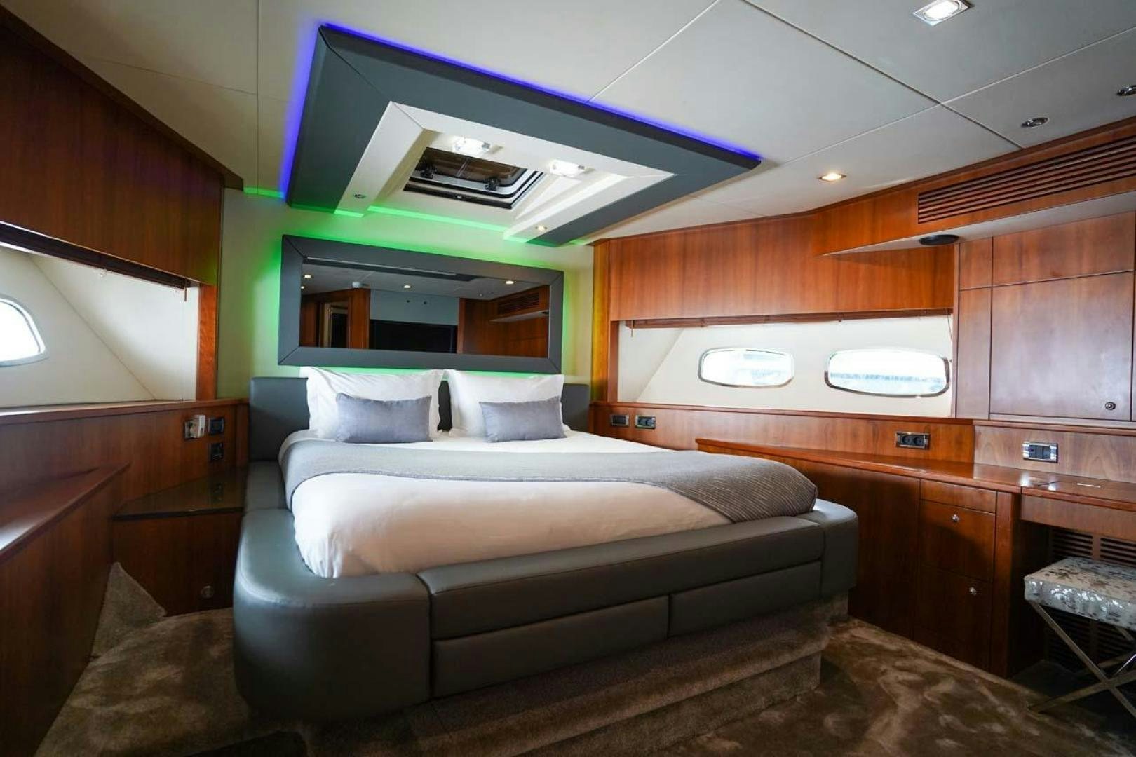 a bedroom with a bed and a desk aboard LI-JOR Yacht for Sale