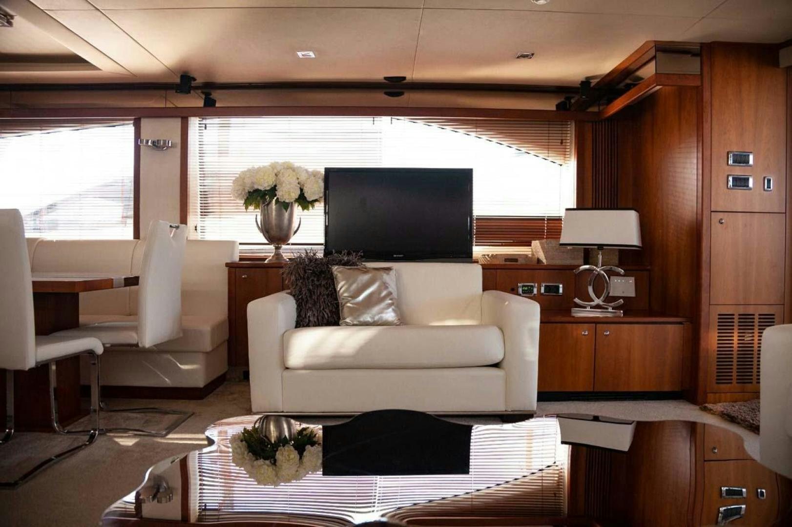 a living room with a large tv aboard LI-JOR Yacht for Sale