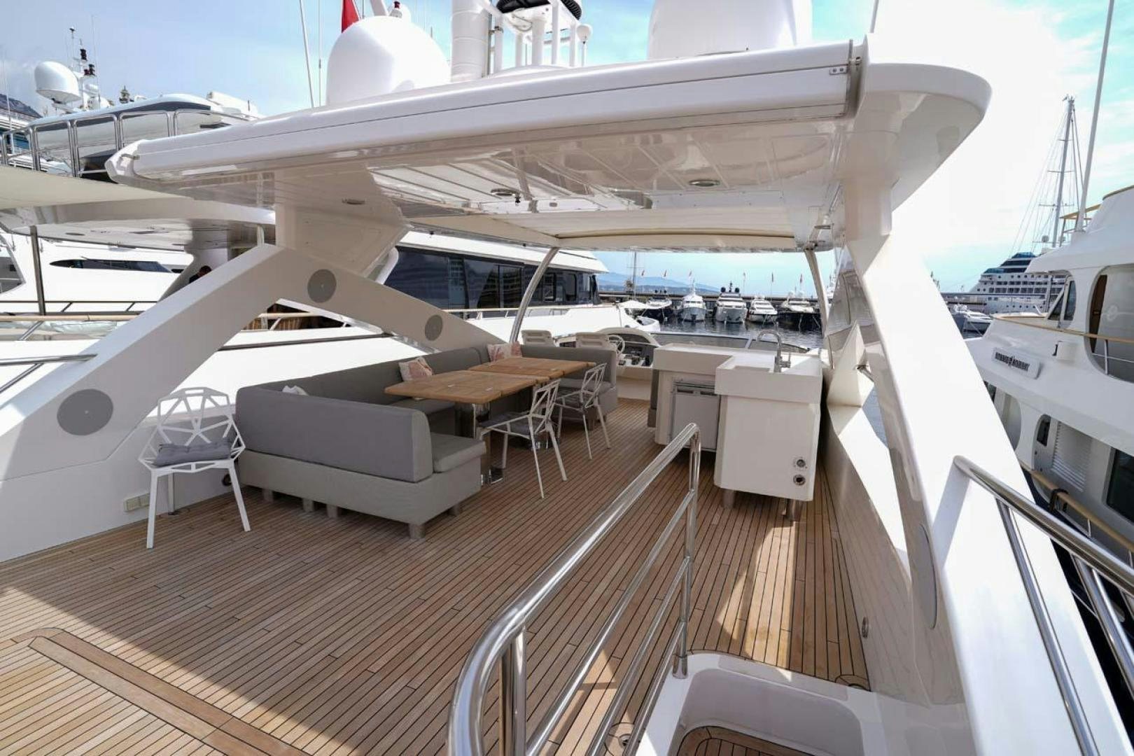 a deck with a large white boat aboard LI-JOR Yacht for Sale