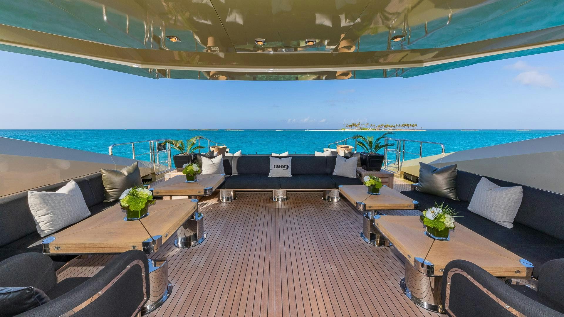 a room with a couch and a table and a pool aboard DB9 Yacht for Sale