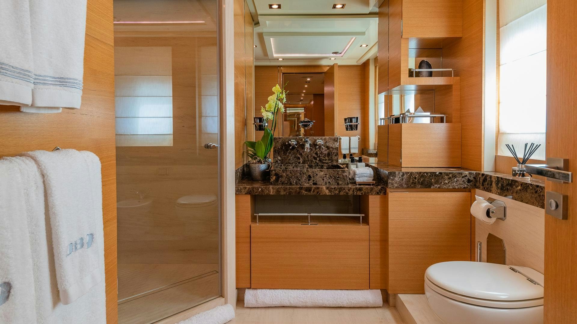a bathroom with a sink toilet and a mirror aboard DB9 Yacht for Sale